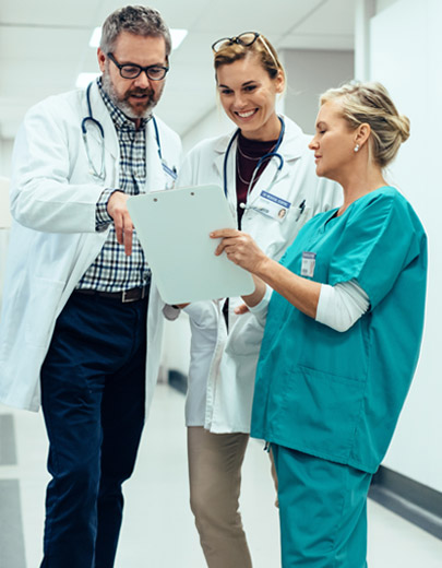 Doctors and a nurse looking at a clipboard together